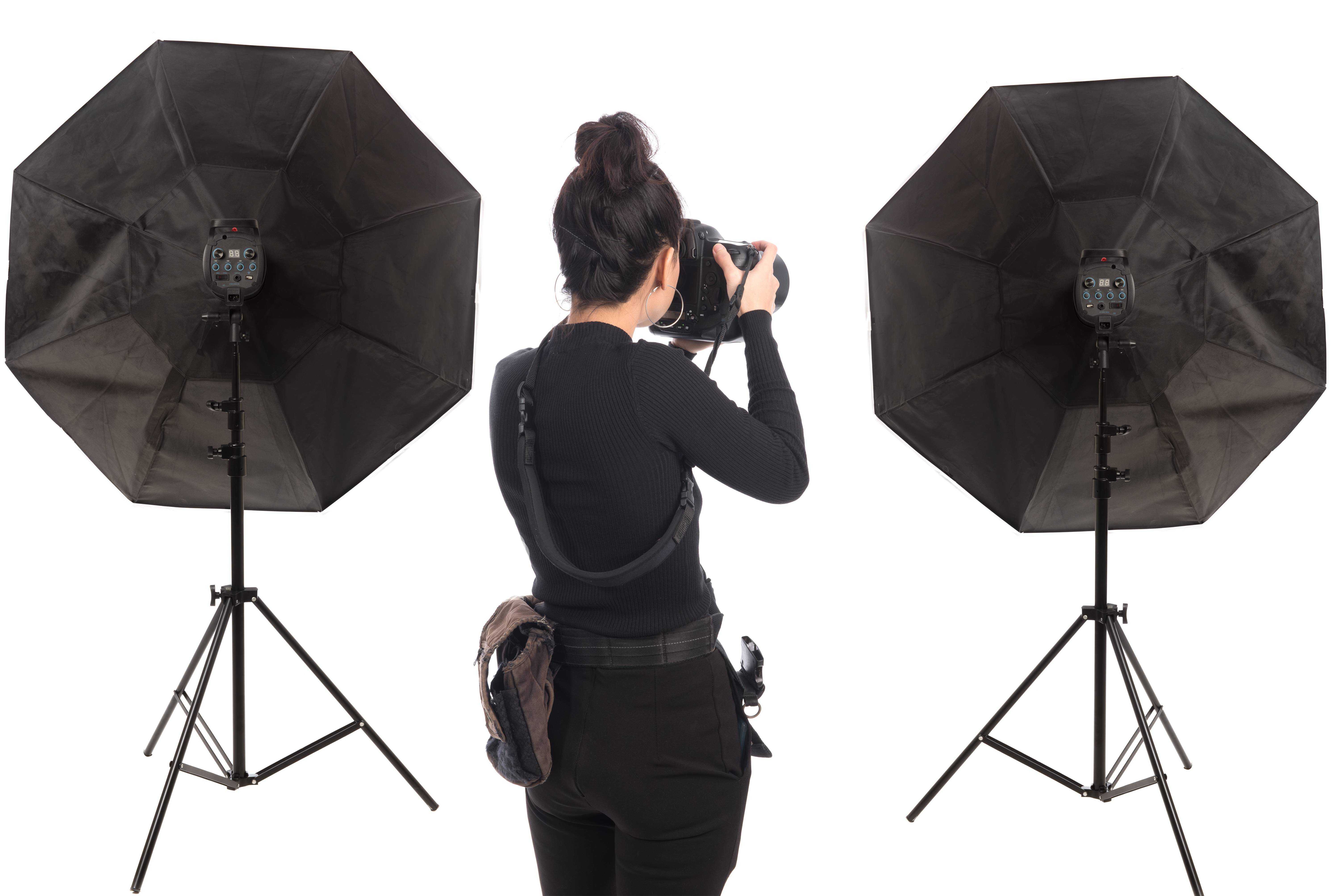 Photographer working l in studio with equipments isolated on white background.