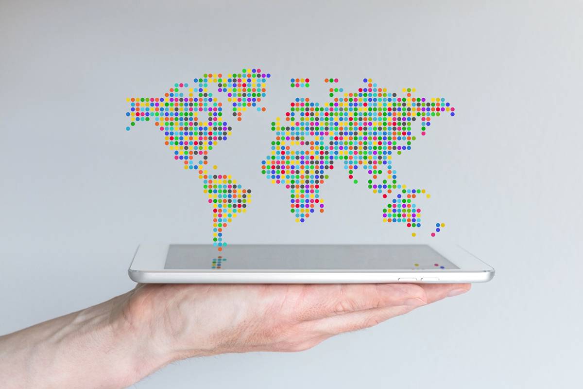 World map floating above a modern smart phone or tablet